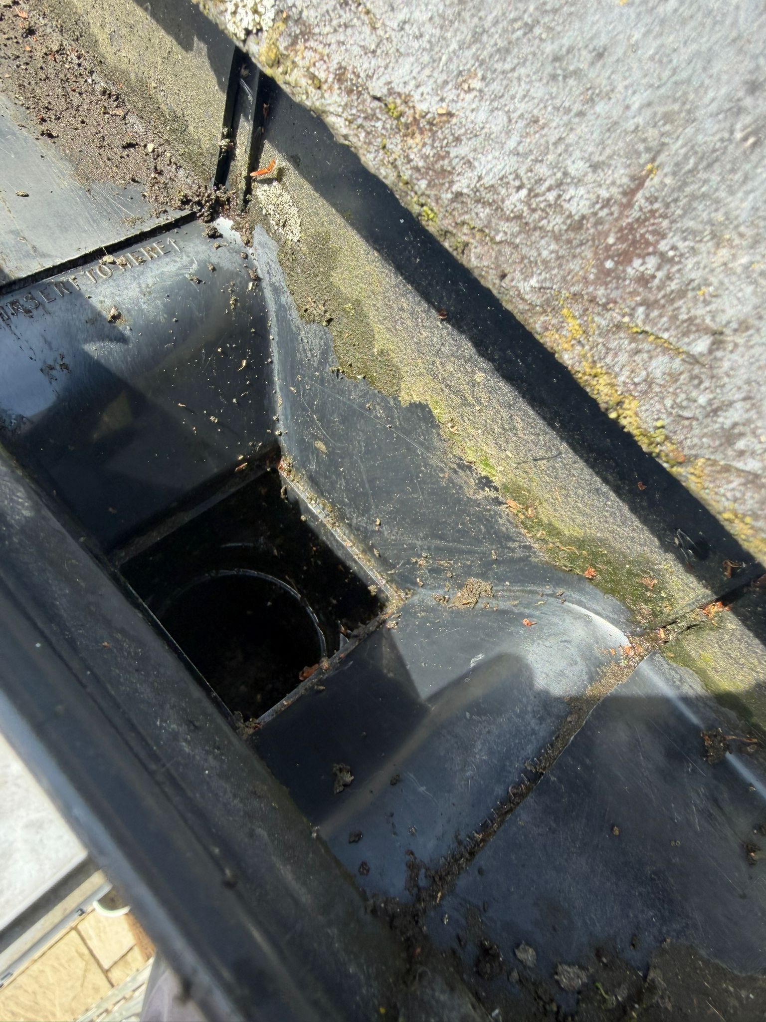 After &ndash; the same gutter outlet cleared, with the downpipe running free again.