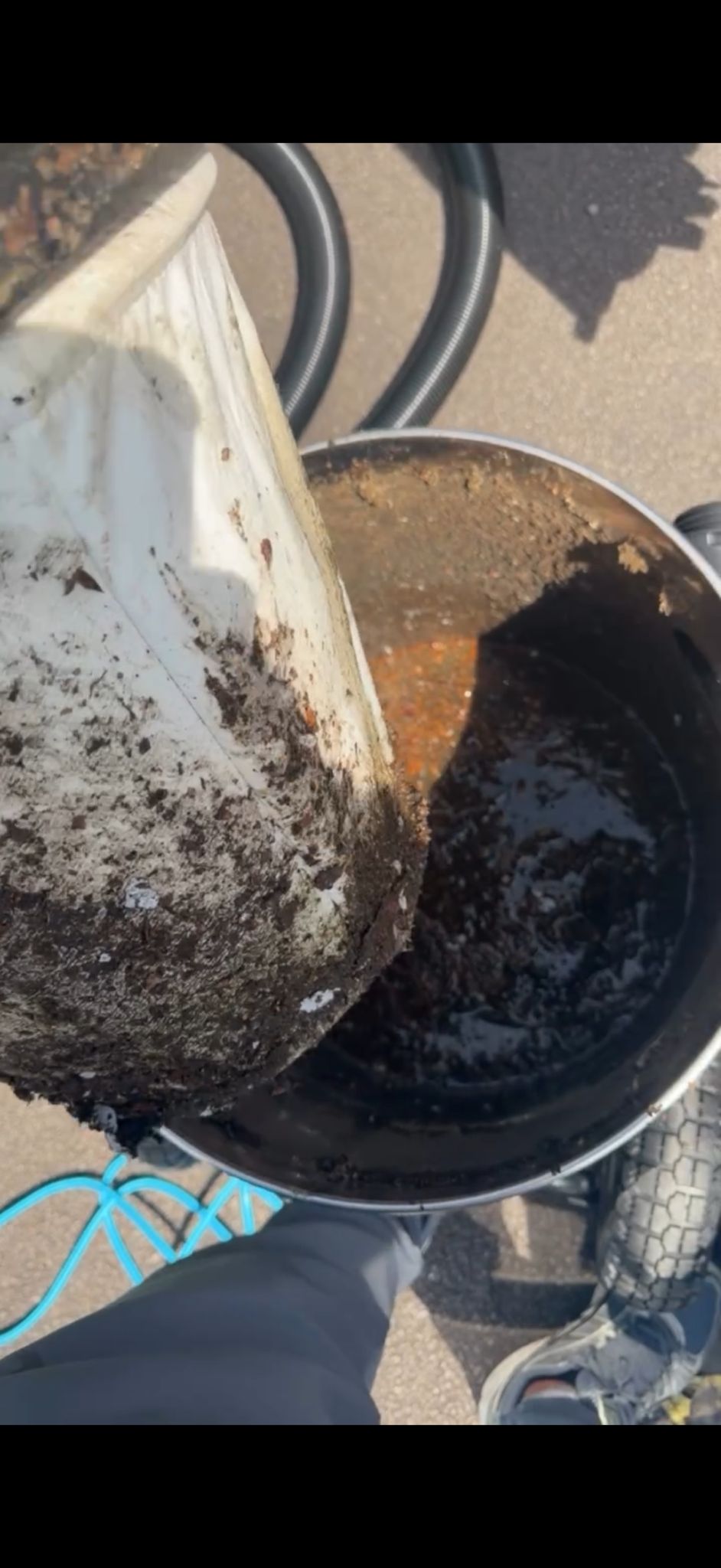 A tub of black silt and moss emptied straight out of a customer's gutter