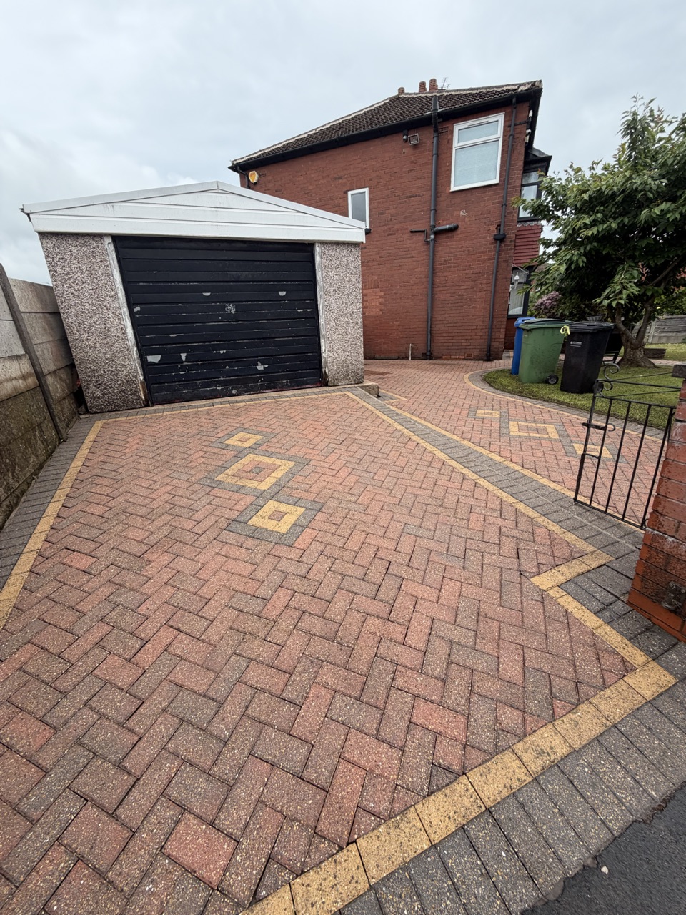 A clean block-paved driveway after pressure washing